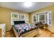 Bright bedroom featuring a bay window with a desk and light wood floors at 220 Gamble Dr, Carrollton, GA 30116