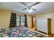 Bedroom features wood floors, a bed with quilt, and natural light from the windows at 220 Gamble Dr, Carrollton, GA 30116