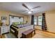 Bright bedroom features a large bed with quilt, wood floors, and a bench at 220 Gamble Dr, Carrollton, GA 30116