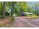 Exterior side view of a well-kept home with mature trees and a long driveway at 220 Gamble Dr, Carrollton, GA 30116