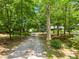 Secluded home featuring a private gravel drive surrounded by lush trees and foliage at 220 Gamble Dr, Carrollton, GA 30116
