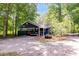 Charming home with carport surrounded by trees offering natural beauty and shade at 220 Gamble Dr, Carrollton, GA 30116