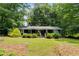 Charming single-story home featuring a well-maintained front yard with mature landscaping at 220 Gamble Dr, Carrollton, GA 30116