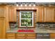 Charming kitchen with wood floors, a red sink and stone backsplash at 220 Gamble Dr, Carrollton, GA 30116