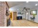 Living room with a brick fireplace, wood floors, and a ceiling fan at 220 Gamble Dr, Carrollton, GA 30116