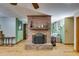 Inviting living room with warm wood floors and a brick fireplace as a central design element at 220 Gamble Dr, Carrollton, GA 30116