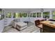 Bright sunroom with hardwood floors and cozy furniture perfect for relaxing and enjoying the view at 220 Gamble Dr, Carrollton, GA 30116