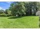 Expansive backyard with lush green lawn, shed, and mature trees creating a private oasis at 2532 Millbrook Dr, Snellville, GA 30078