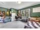 Bedroom with green walls, guitar, bookshelves, desk, and comfortable looking bed at 2532 Millbrook Dr, Snellville, GA 30078