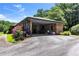 Brick carport featuring an open layout with a paved driveway and surrounding greenery at 2532 Millbrook Dr, Snellville, GA 30078