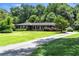 A single story brick home with a long, paved driveway winding through the verdant front yard at 2532 Millbrook Dr, Snellville, GA 30078