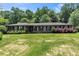 Charming brick home featuring lush lawn, mature trees, and meticulously maintained landscaping at 2532 Millbrook Dr, Snellville, GA 30078