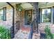 Inviting front porch with brick flooring, decorative ironwork, and classic architectural details at 2532 Millbrook Dr, Snellville, GA 30078