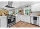 Modern kitchen with stainless steel appliances, white cabinetry, and ample counter space at 2532 Millbrook Dr, Snellville, GA 30078