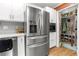 Stainless steel refrigerator and storage in the kitchen, with convenient access to a washer and dryer in the walk-in pantry at 2532 Millbrook Dr, Snellville, GA 30078