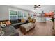 Open concept living room with wood floors, a cozy couch, and easy access to the kitchen at 2532 Millbrook Dr, Snellville, GA 30078