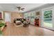 Inviting living room with wood floors, a ceiling fan, and a sliding glass door to the backyard at 2532 Millbrook Dr, Snellville, GA 30078