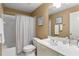 Clean bathroom with a shower-tub combo, a white vanity, and a large mirror reflecting beach themed art at 290 Edwardton Ct, Roswell, GA 30076