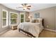 Bright bedroom with large windows, ceiling fan, and a cozy atmosphere at 290 Edwardton Ct, Roswell, GA 30076