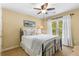 Inviting bedroom with a ceiling fan, natural light, and comfortable bedding at 290 Edwardton Ct, Roswell, GA 30076
