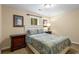 Comfortable bedroom with a plush bed, a window for natural light, and a nightstand with lamp at 290 Edwardton Ct, Roswell, GA 30076