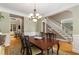 Traditional dining room with hardwood floors, chandelier, and wainscoting, flowing into the living area at 290 Edwardton Ct, Roswell, GA 30076