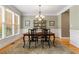 Formal dining room with hardwood floors, elegant lighting, and large window for natural light at 290 Edwardton Ct, Roswell, GA 30076