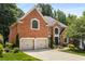Beautiful brick home featuring a two-car garage and well-maintained landscaping, offering classic elegance at 290 Edwardton Ct, Roswell, GA 30076