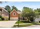 Traditional brick home with an attached two-car garage, manicured landscaping, and a welcoming entrance at 290 Edwardton Ct, Roswell, GA 30076