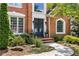 Elegant brick home entrance with double doors, manicured landscaping, and a welcoming walkway at 290 Edwardton Ct, Roswell, GA 30076