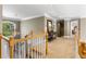 Spacious hallway with chandelier and decorative mirror leading to the main bedroom at 290 Edwardton Ct, Roswell, GA 30076
