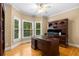 Dedicated home office with hardwood floors, built-in desk, and plentiful natural light at 290 Edwardton Ct, Roswell, GA 30076