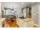 Open kitchen showcasing granite counters, an island cooktop, and views into other living spaces at 290 Edwardton Ct, Roswell, GA 30076