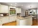 Inviting kitchen features granite countertops, an island cooktop, and eat-in dining area at 290 Edwardton Ct, Roswell, GA 30076