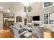 Bright living room features a fireplace, built-in shelving, and views into the open kitchen at 290 Edwardton Ct, Roswell, GA 30076