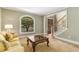 Comfortable living room featuring a large window, elegant stairs, and a view of the front yard at 290 Edwardton Ct, Roswell, GA 30076