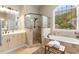 Spa-like main bathroom with soaking tub, glass shower, double vanity, and arched window at 290 Edwardton Ct, Roswell, GA 30076