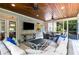 Cozy screened porch featuring comfortable seating and an outdoor dining area with wooded views at 290 Edwardton Ct, Roswell, GA 30076