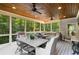 Spacious screened porch with an outdoor dining area and comfortable seating for entertaining guests at 290 Edwardton Ct, Roswell, GA 30076