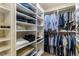 Well-organized walk-in closet with shelving and hanging space for clothes and accessories at 290 Edwardton Ct, Roswell, GA 30076