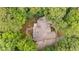 Overhead shot showcasing a home nestled amidst lush trees with well-manicured landscaping at 4435 Pemberton Cv, Johns Creek, GA 30022