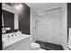 The bathroom features a glass shower, white geometric wall tiles, and dark gray walls at 4435 Pemberton Cv, Johns Creek, GA 30022