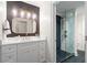Modern bathroom with white cabinets, shower with a glass door, and striking herringbone tile floor at 4435 Pemberton Cv, Johns Creek, GA 30022