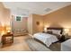 A bedroom features neutral walls, a window, a carpeted floor, and a queen-size bed at 4435 Pemberton Cv, Johns Creek, GA 30022