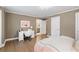 Cozy bedroom featuring hard wood floors, a desk, and an ensuite bathroom with a peek at the bathroom at 4435 Pemberton Cv, Johns Creek, GA 30022
