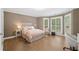 Bright and airy bedroom with a bay window and a combination of neutral and pink decor at 4435 Pemberton Cv, Johns Creek, GA 30022