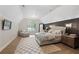 Spacious bedroom with a large window, rug and TV on the wall at 4435 Pemberton Cv, Johns Creek, GA 30022