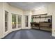 The bonus room features built-in shelves, a storage bench, and French doors to the exterior at 4435 Pemberton Cv, Johns Creek, GA 30022