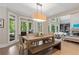 Cozy dining area with natural light and views overlooking outdoor deck and fireplace at 4435 Pemberton Cv, Johns Creek, GA 30022