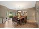 Elegant dining room featuring hardwood floors, wainscoting, and a bay window with a view of the yard at 4435 Pemberton Cv, Johns Creek, GA 30022
